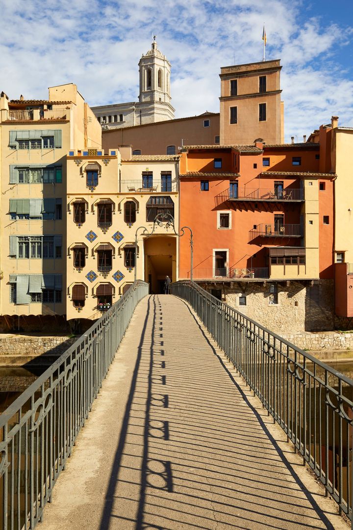 A bridge over a river with buildings in the background