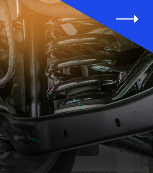 Car suspension system with black coil spring and metal frame.