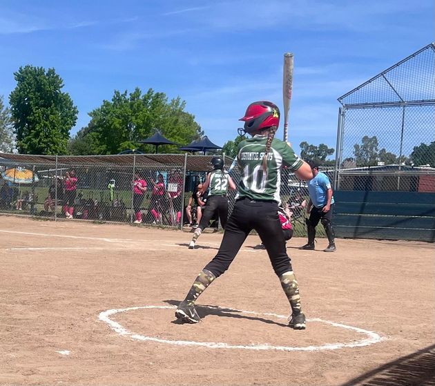 Baseball player sliding into home plate, catcher in front. Blue and gold uniforms, action shot.