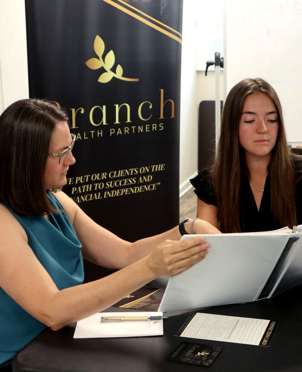 Two women discussing real estate investing during a Branch Wealth Partners mentorship session.