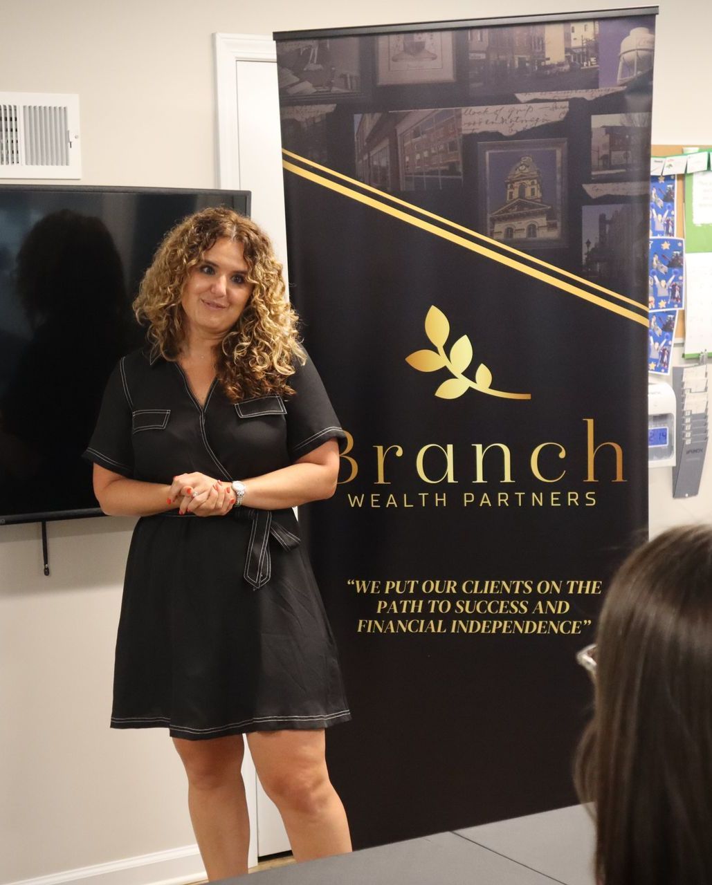 Curly hair woman teaching real estate investing class with Branch Wealth Partners