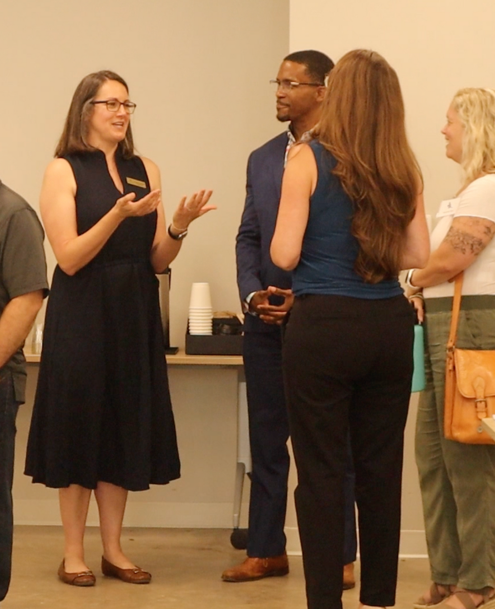 Professionals networking and discussing real estate during a Branch Wealth Partners event.