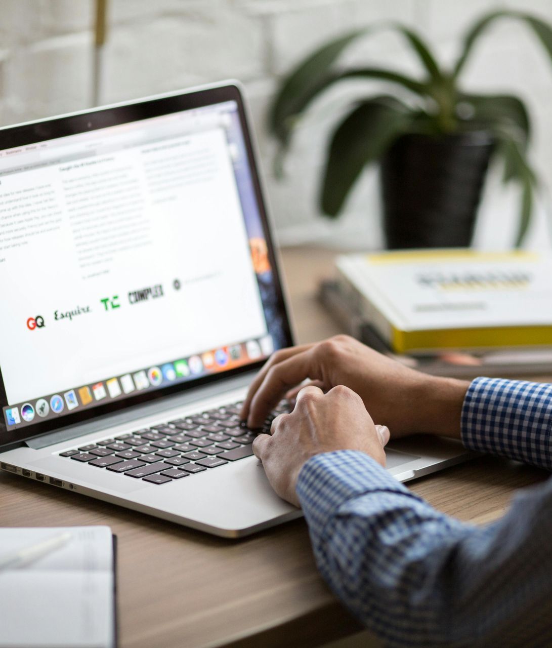 Close-up of a person using a laptop to register for a real estate investing mentorship program.