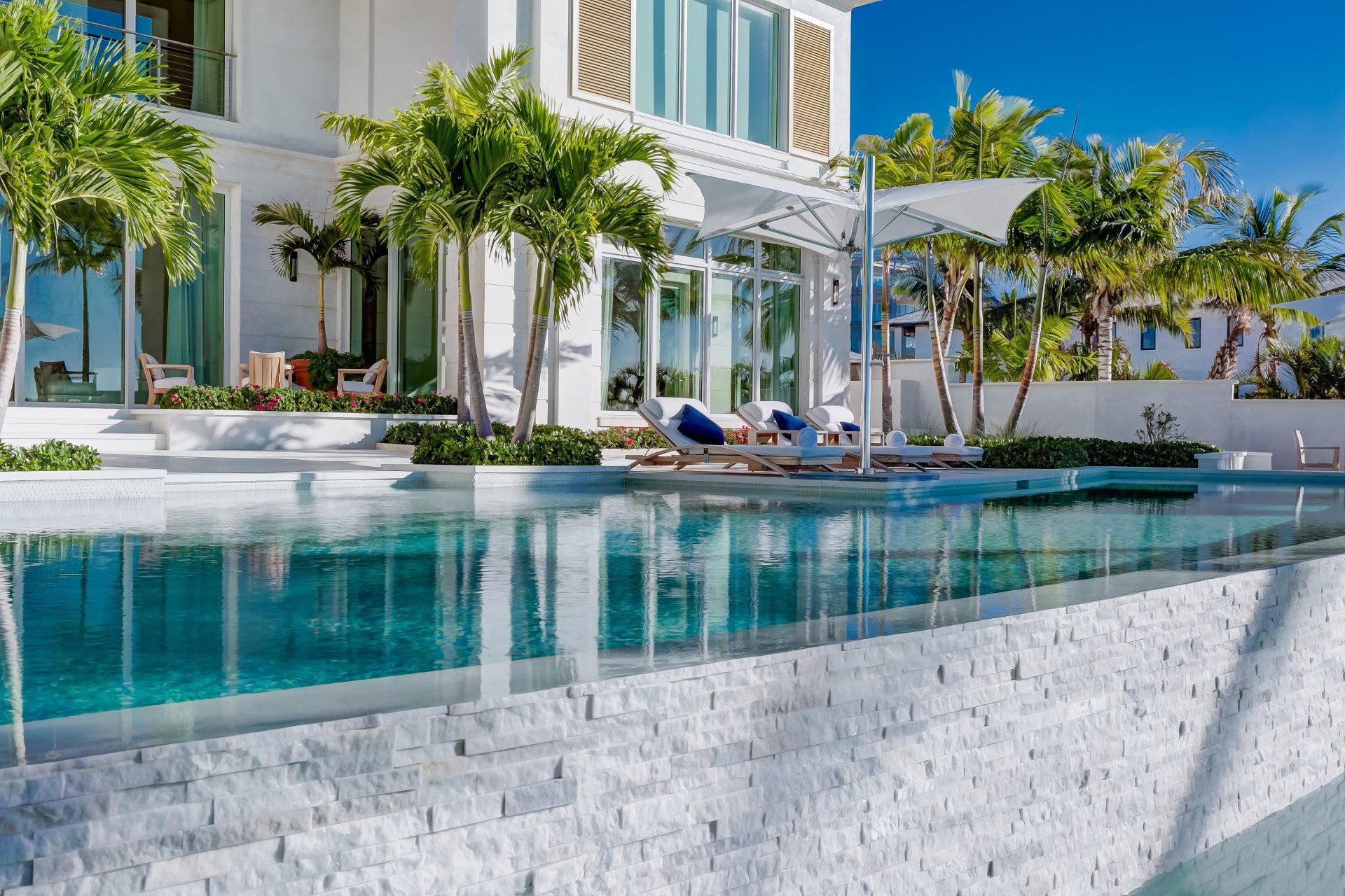 A large luxury white house with a swimming pool in the backyard shoot by Craig Westerman A large luxury white house with a swimming pool in the backyard shoot by Craig Westerman