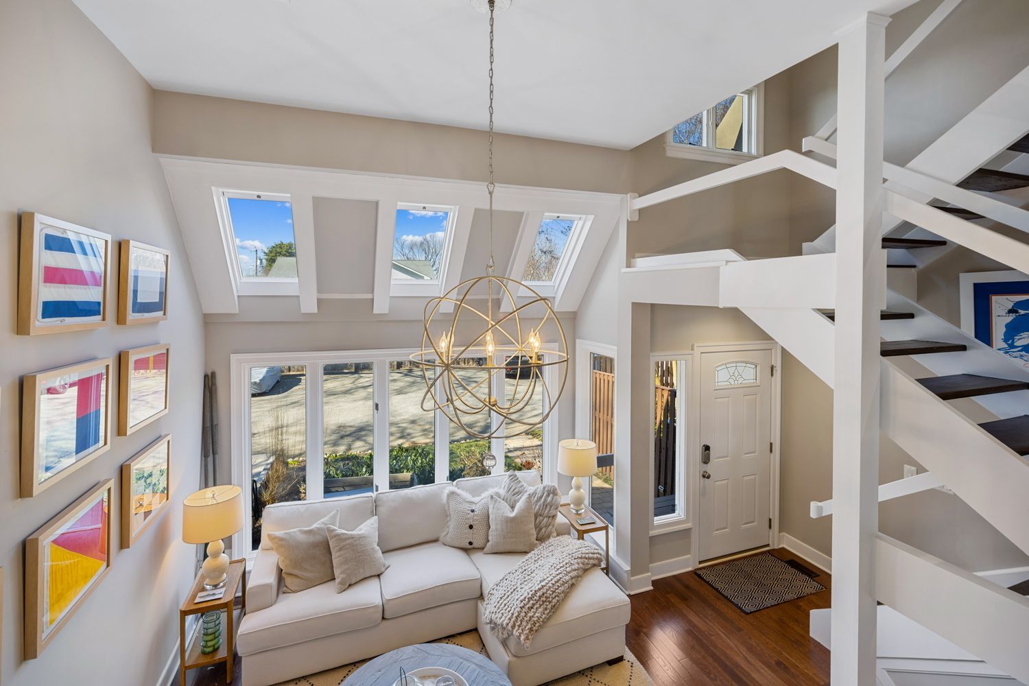 Annapolis, Maryland. Beautiful white focused living room with large open windows. Photo shoot by Craig Westerman.
