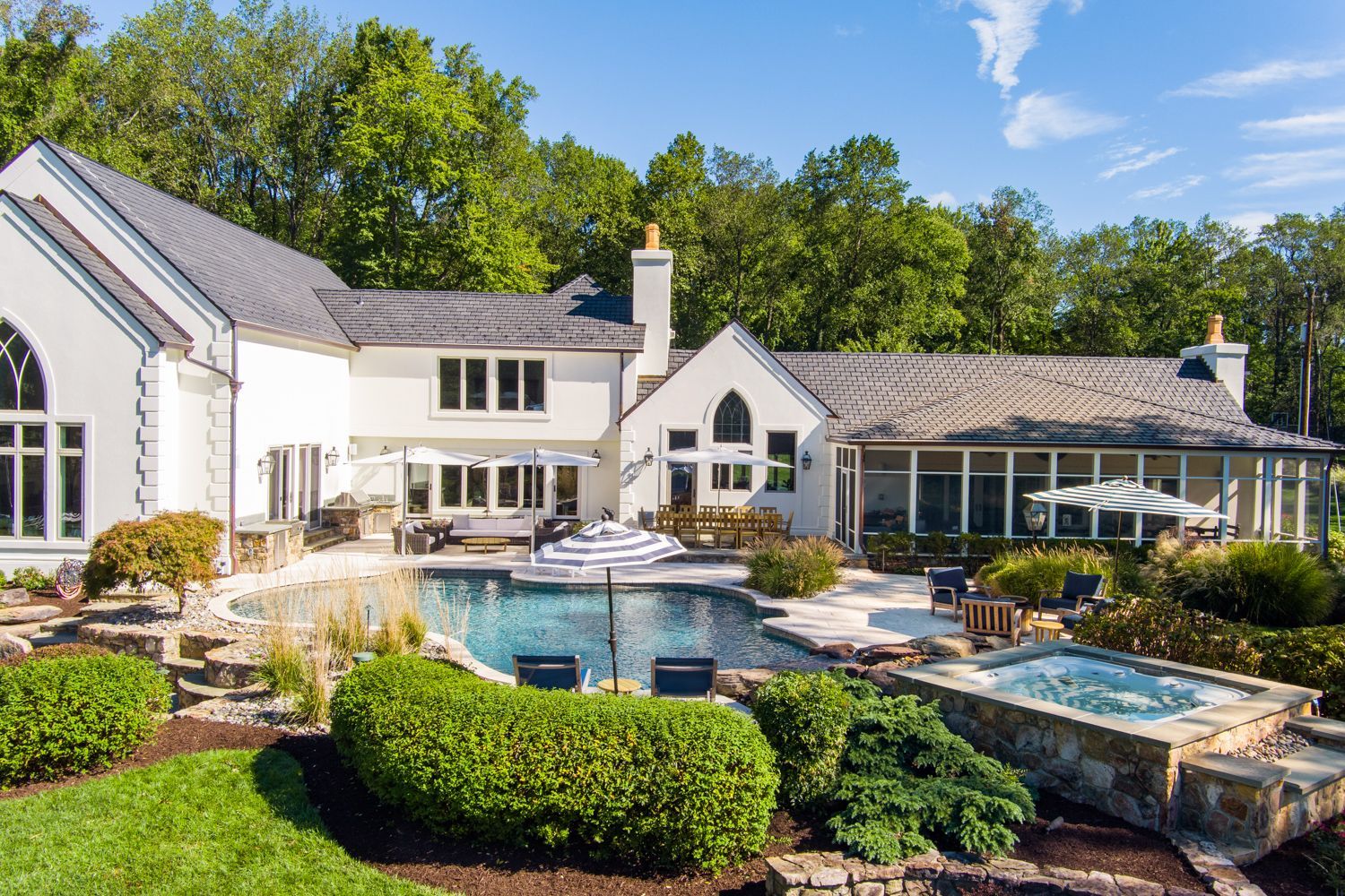 Annapolis, Maryland. A large luxury white brick home with a large swimming pool in the backyard. Photo shoot by Craig Westerman.