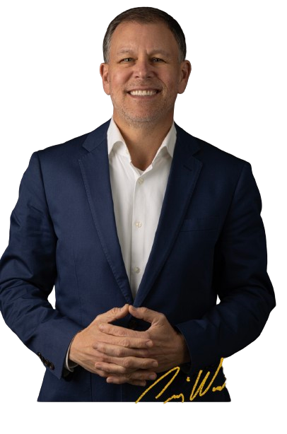 A man in a blue suit and white shirt is smiling.