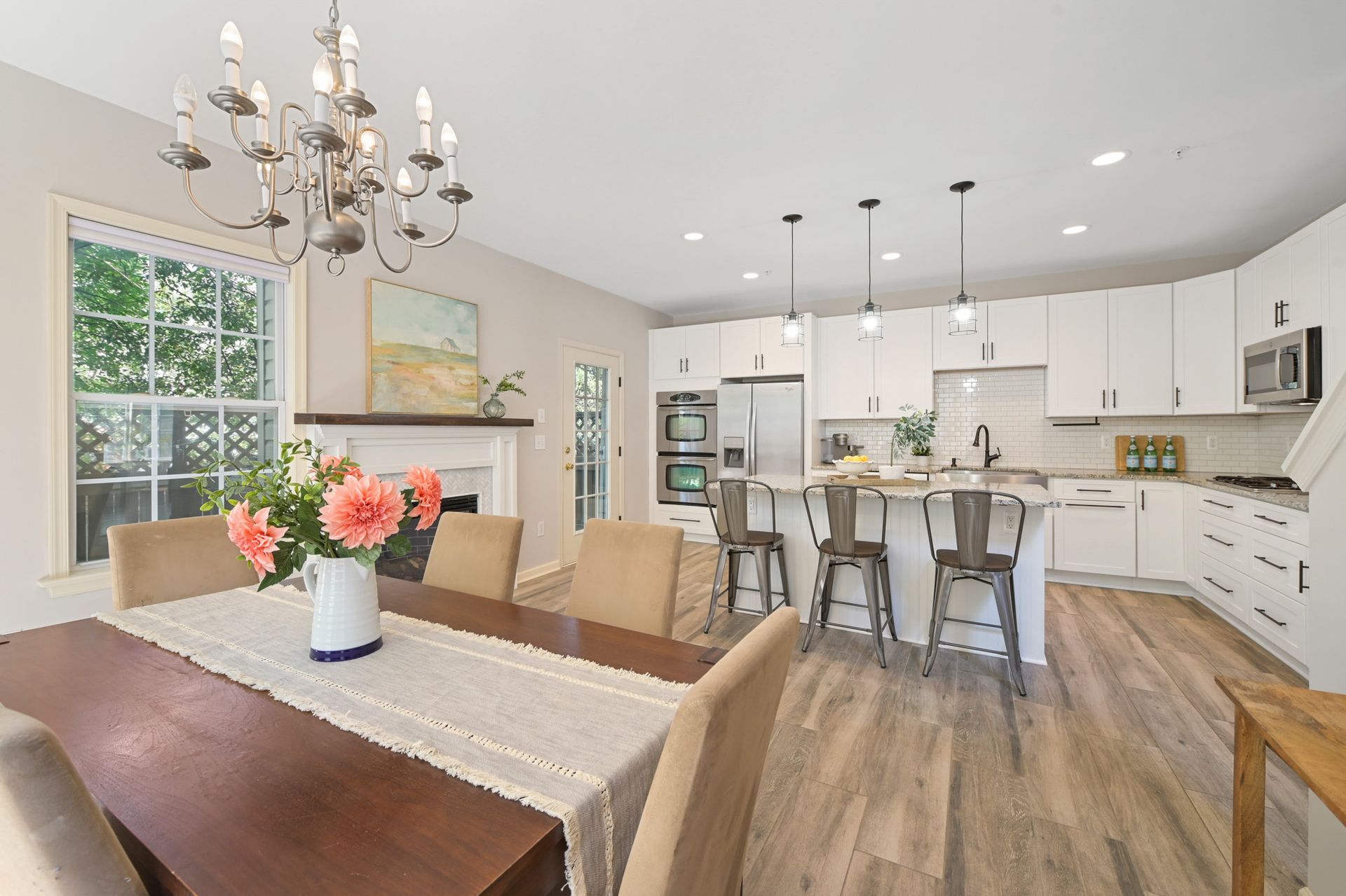 A dining room table with a vase of flowers on it in a kitchen in Clarksville, Maryland photo shoot by Craig Westerman.