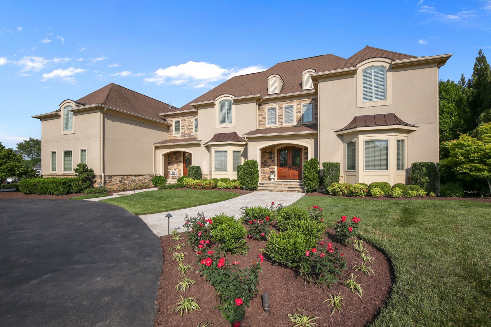 A large house with a lot of windows and flowers in front of it. Outdoor shoot by Craig Westerman.