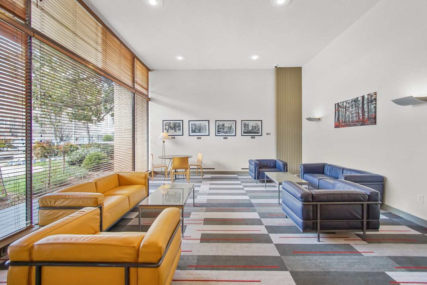 A living room with a lot of furniture and a large window.