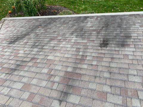 Pressure washing siding of house