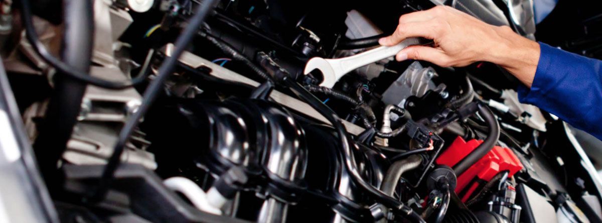 Close-Up Of Mechanic Tightening Bolts On Car Engine | Dale's Auto Service