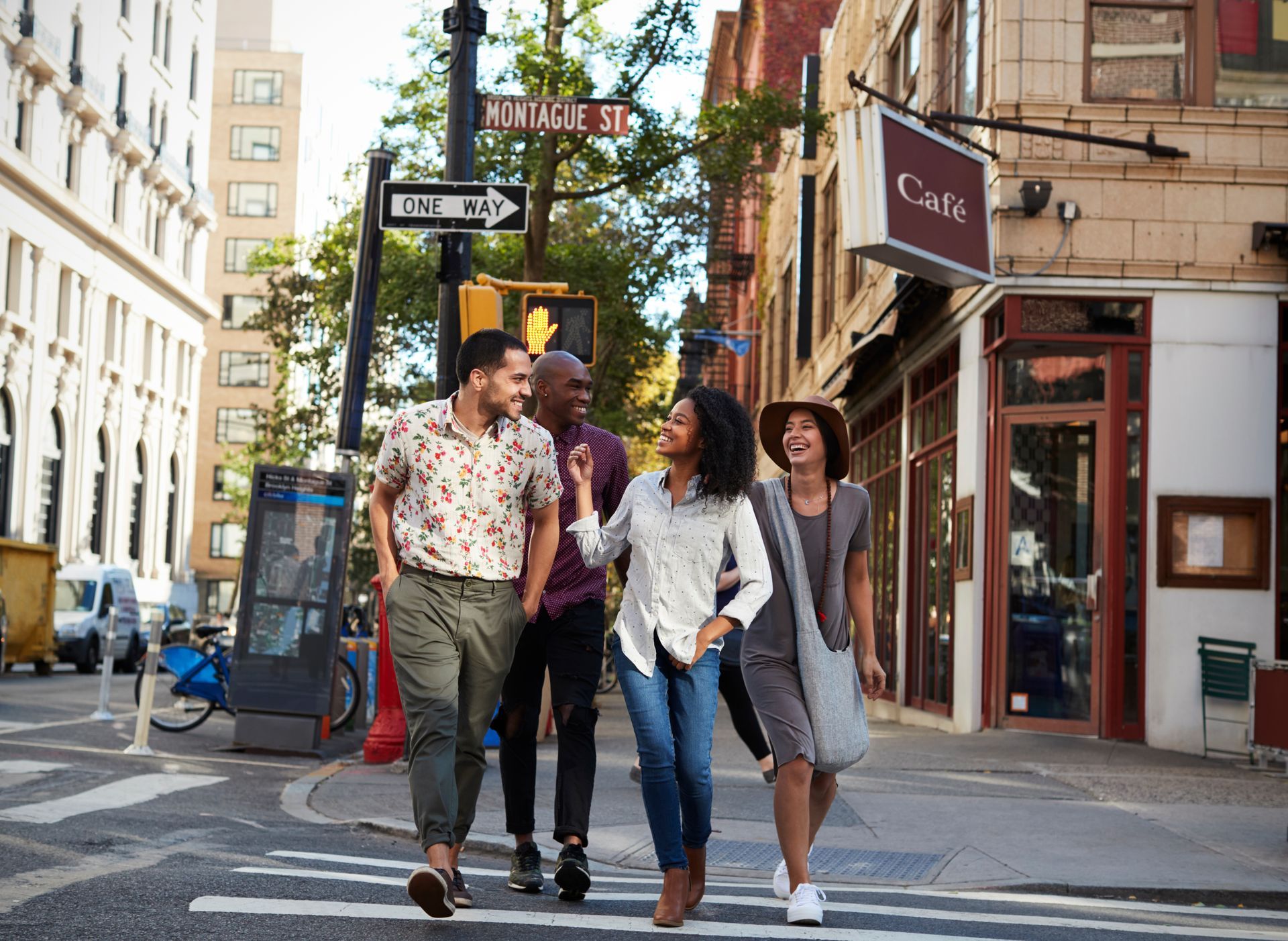 A group of people are walking down a city street.