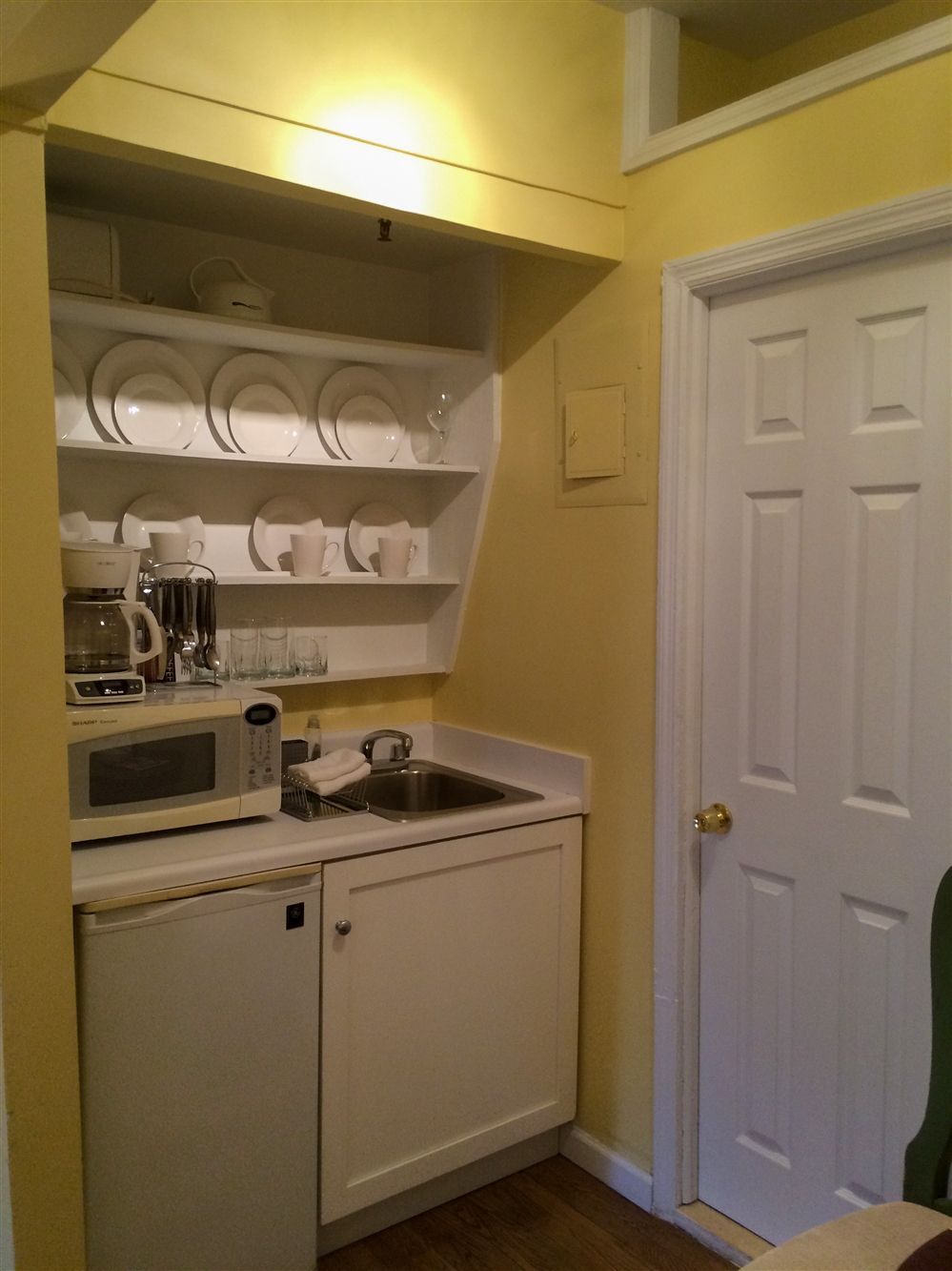 a kitchen with a sink a microwave and a coffee maker