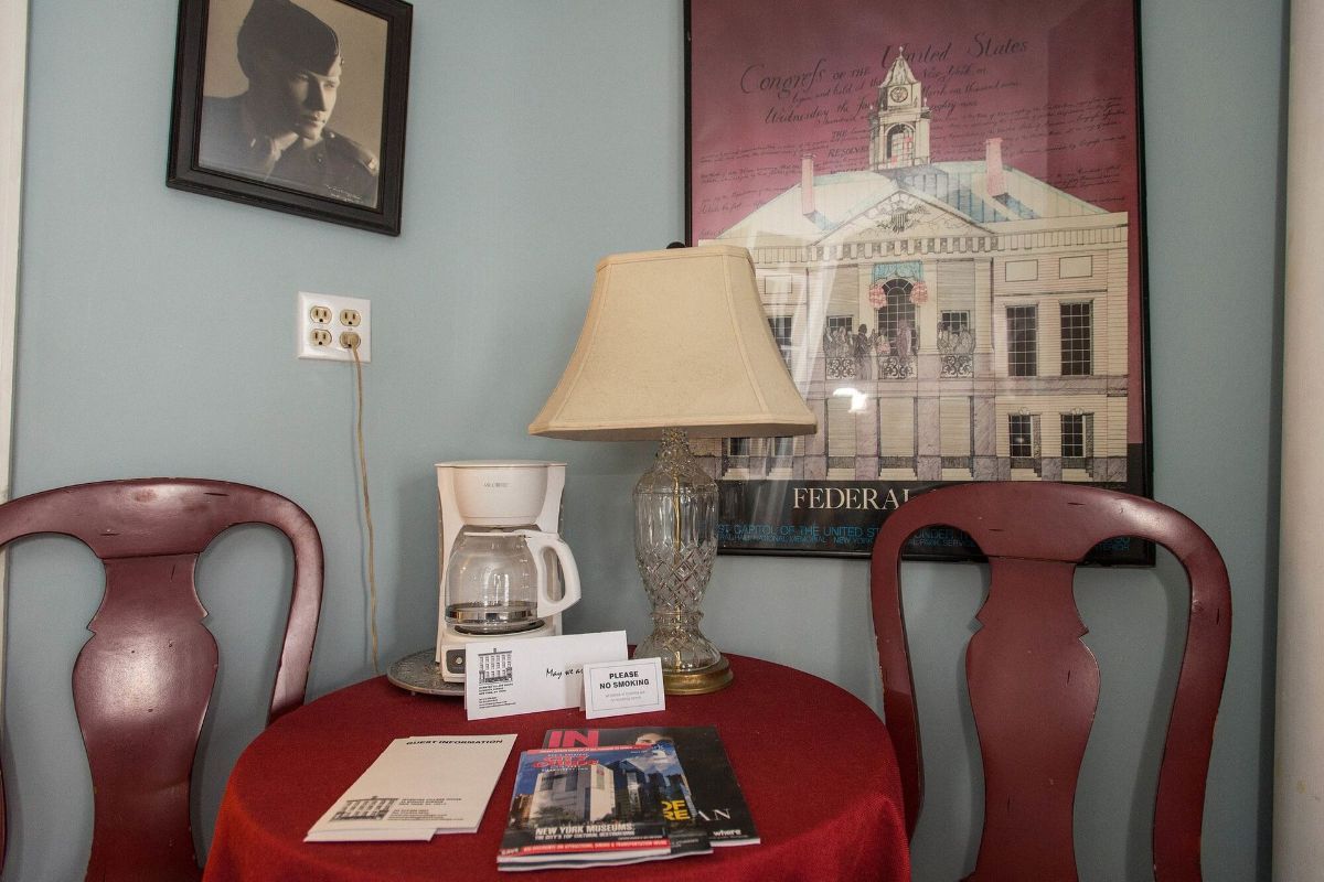 a table with a lamp and a coffee maker on it