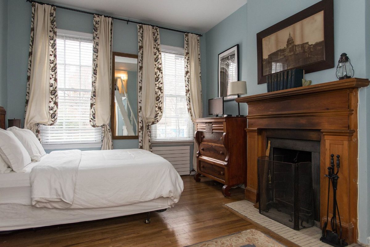 a bedroom with a fireplace and a bed