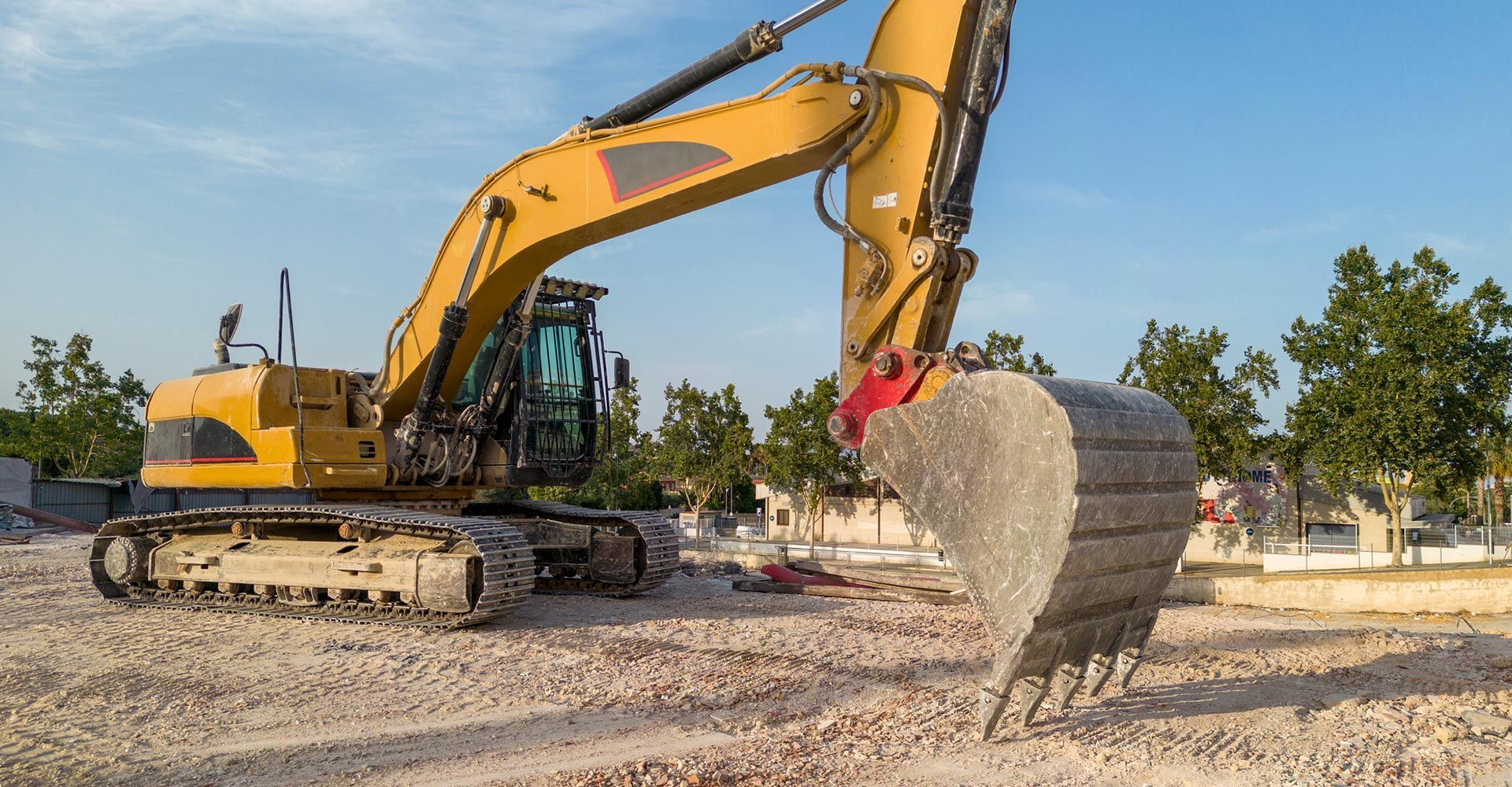 A large yellow excavator is working on a construction site. A large yellow excavator is working on a construction site.