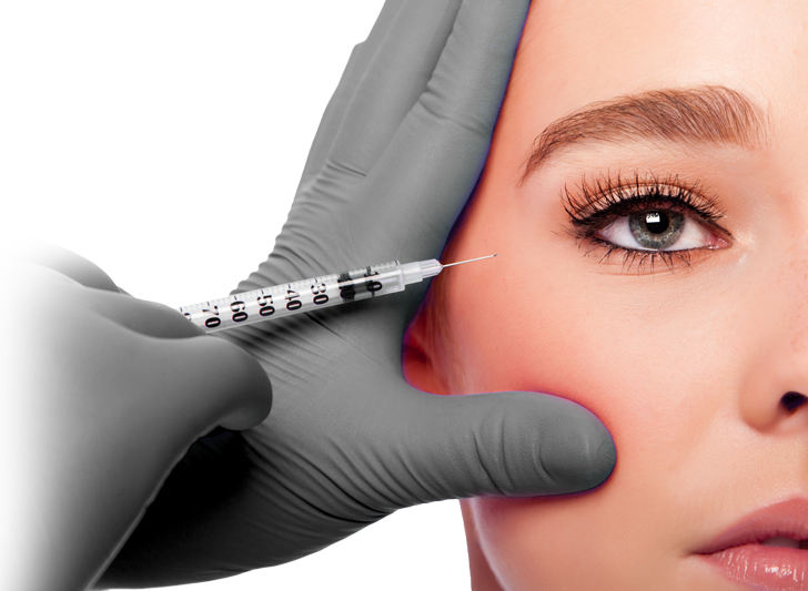 A woman is getting a botox injection in her cheek
