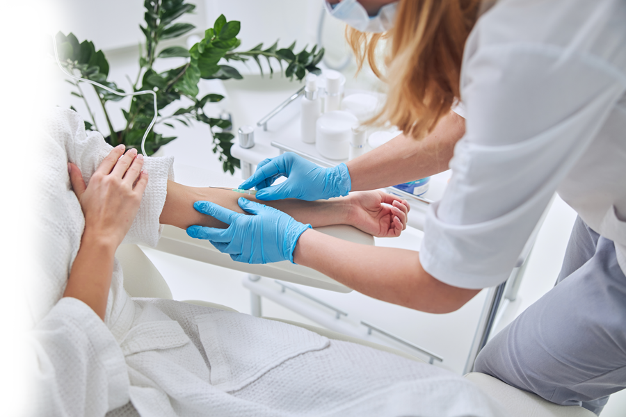 A woman is getting an injection in her arm.