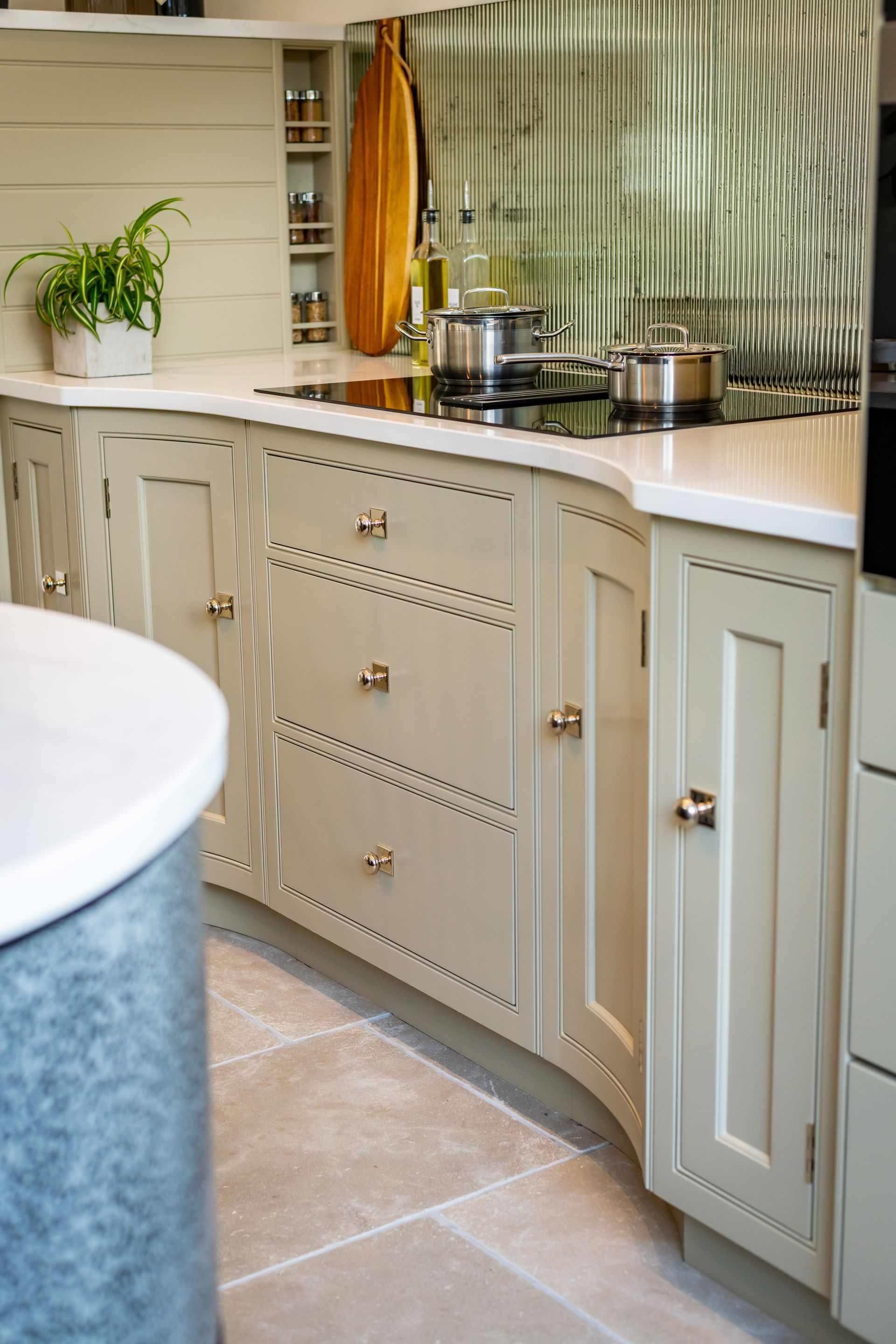 A kitchen with white cabinets and a stove top oven.