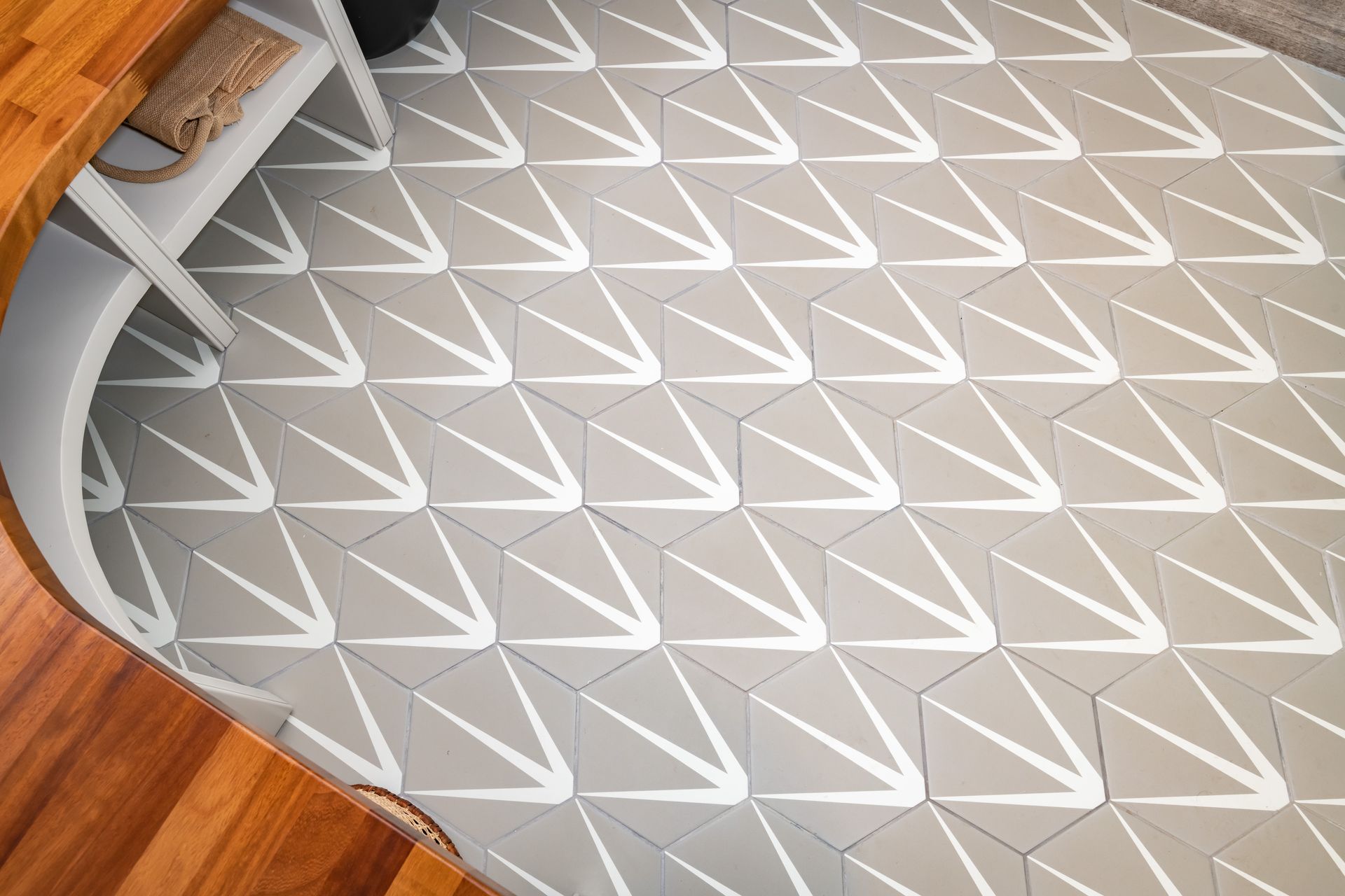 A close up of a tile floor with a geometric pattern.
