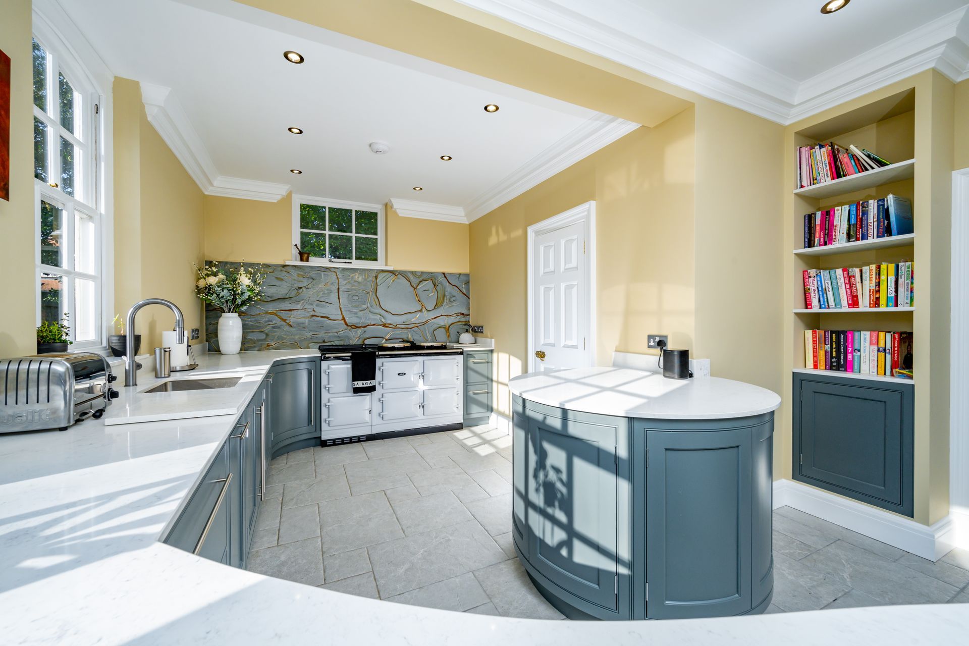 A kitchen with a stainless steel refrigerator and a sink.