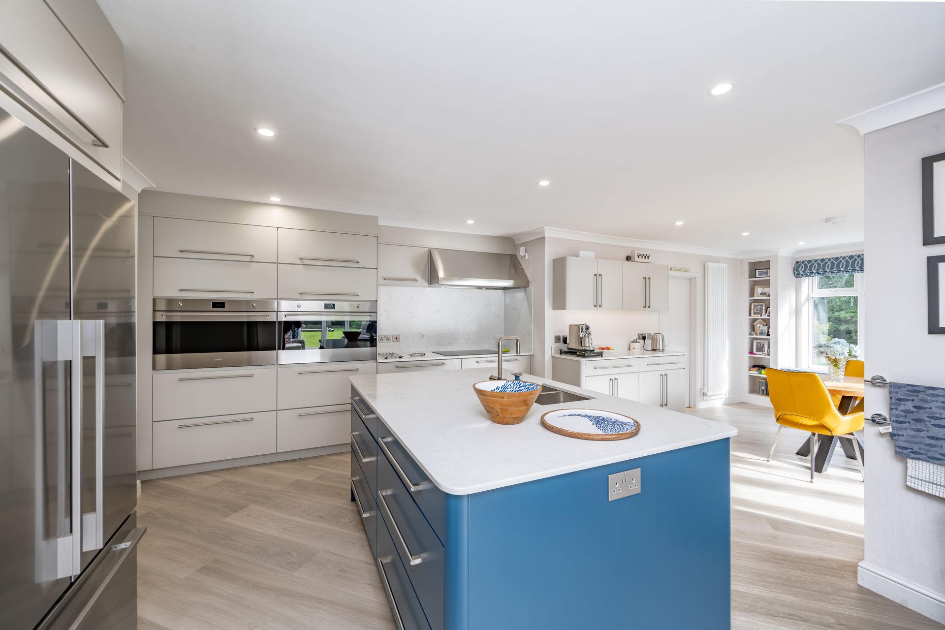 A kitchen with a stainless steel refrigerator and a sink.
