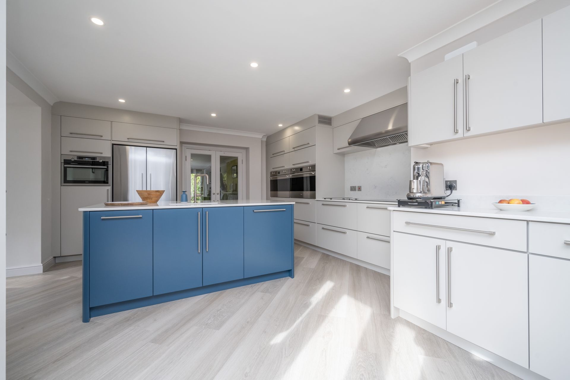 A kitchen with blue cabinets and white cabinets