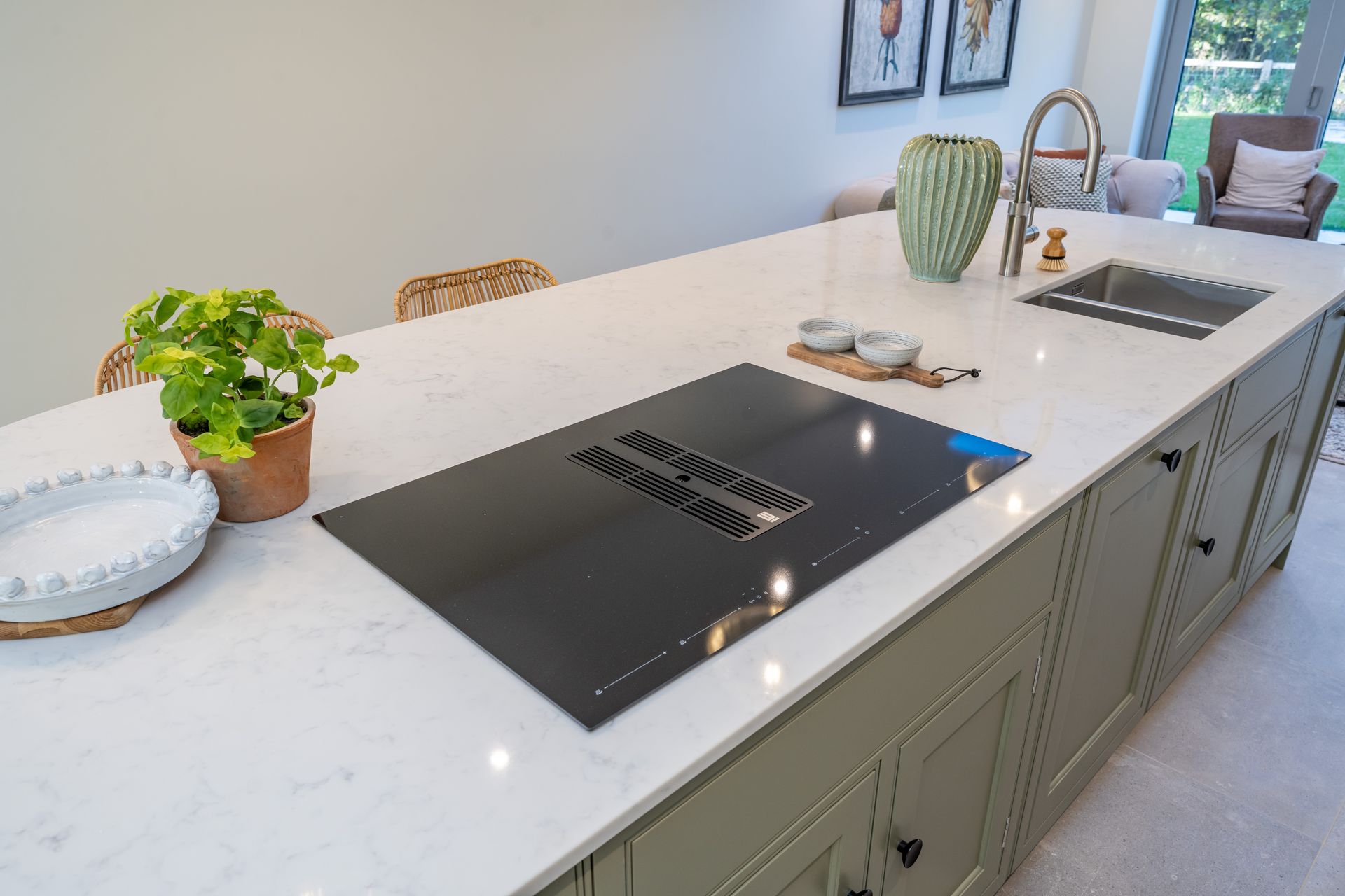 A stainless steel refrigerator is sitting under a cabinet in a kitchen.