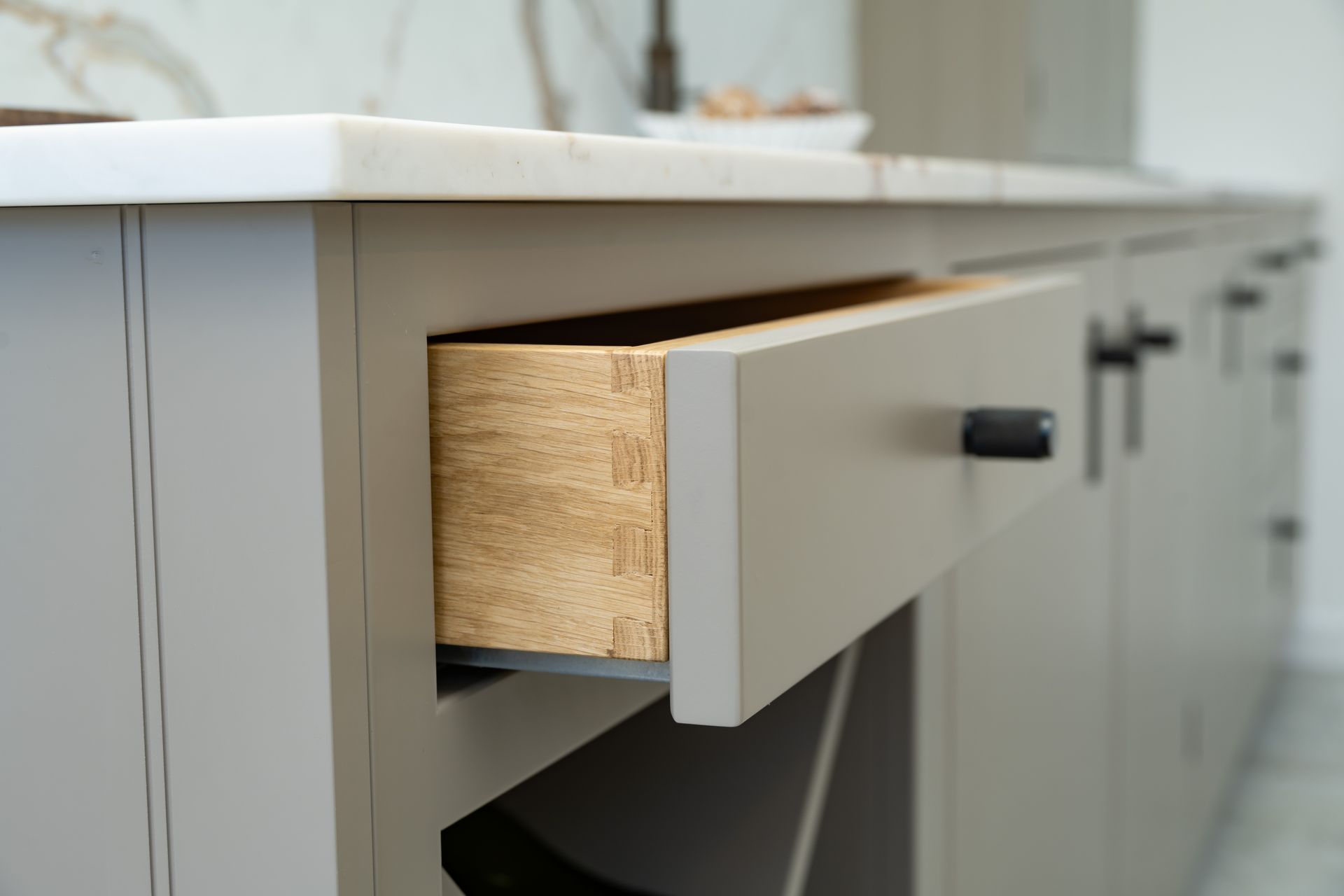 A close up of an open drawer in a kitchen.
