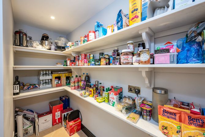 A pantry filled with lots of food and drinks.