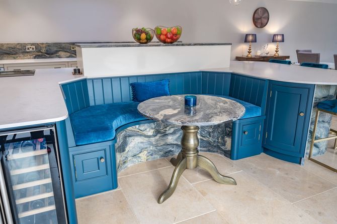 A kitchen with blue cabinets and a round table