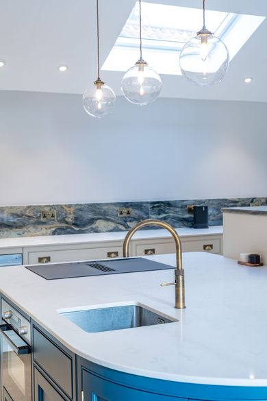 A kitchen with a blue island and a white counter top