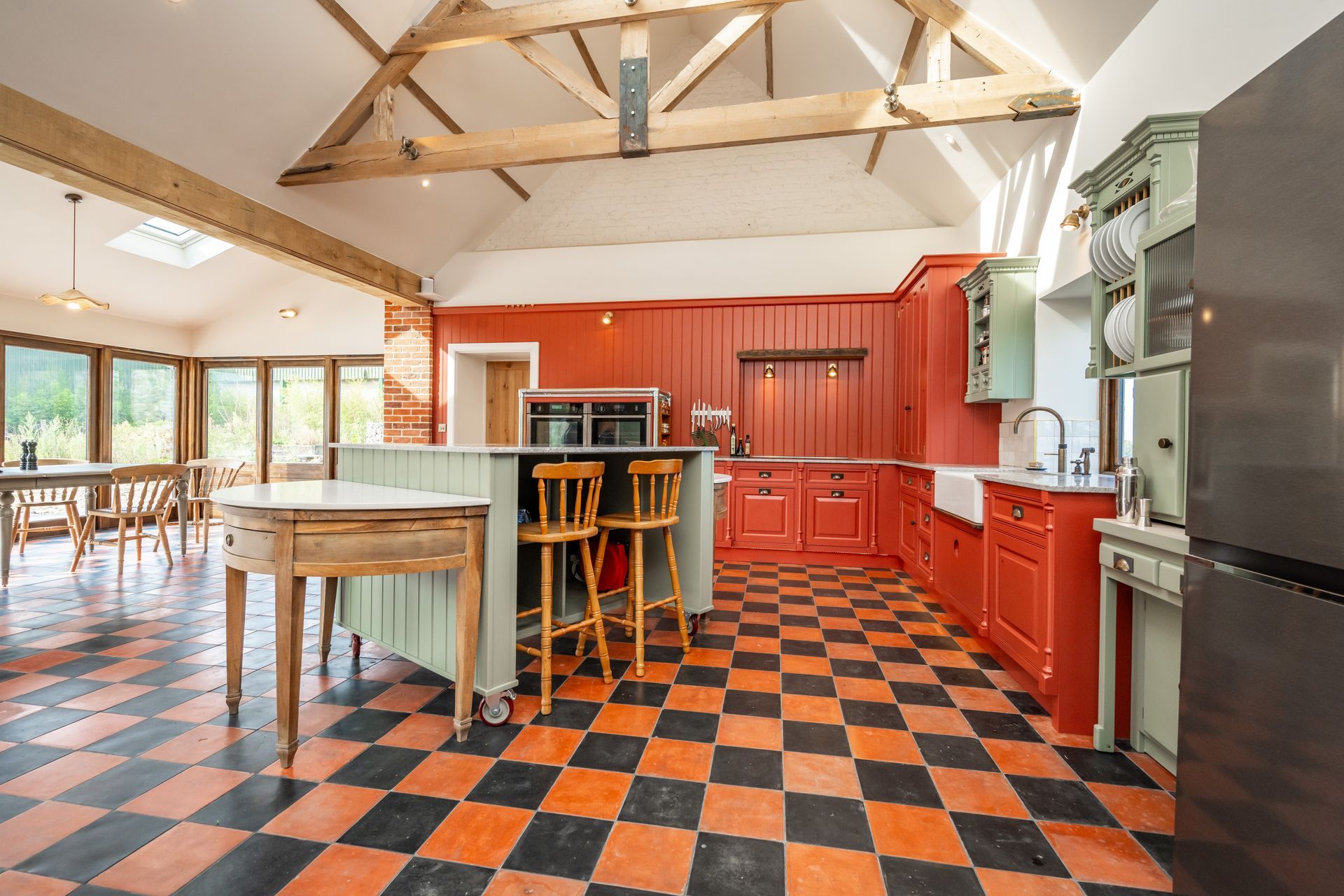 A kitchen with a stainless steel refrigerator and a sink.