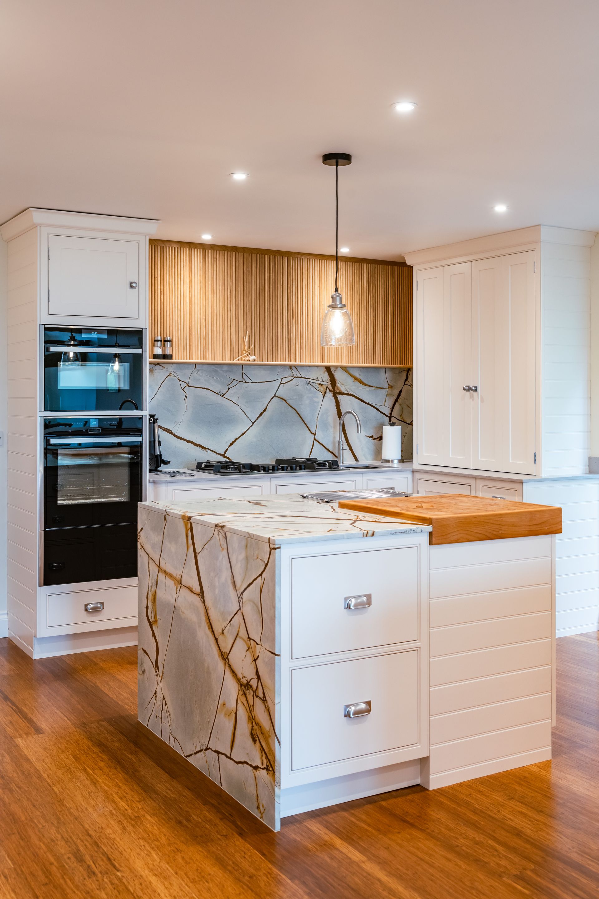 A kitchen with stainless steel appliances and a wine cooler.