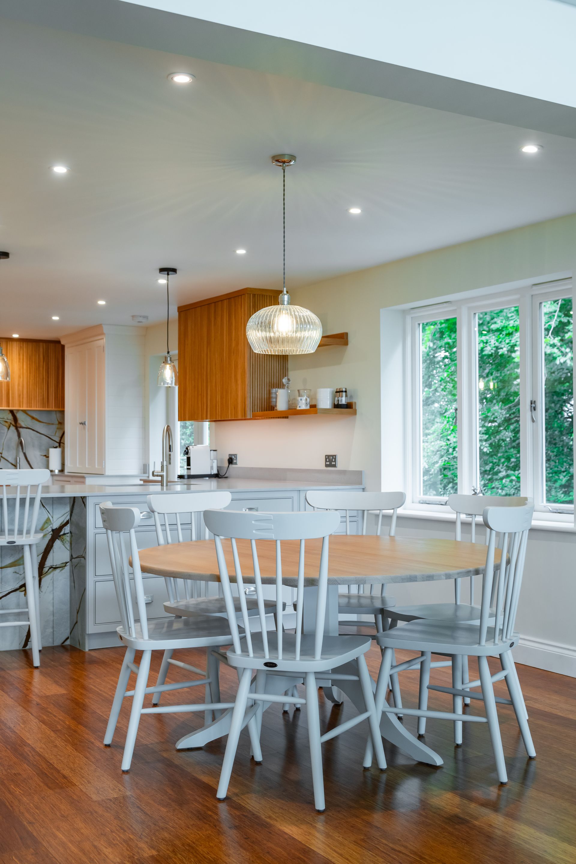 A kitchen with a table and chairs in it.