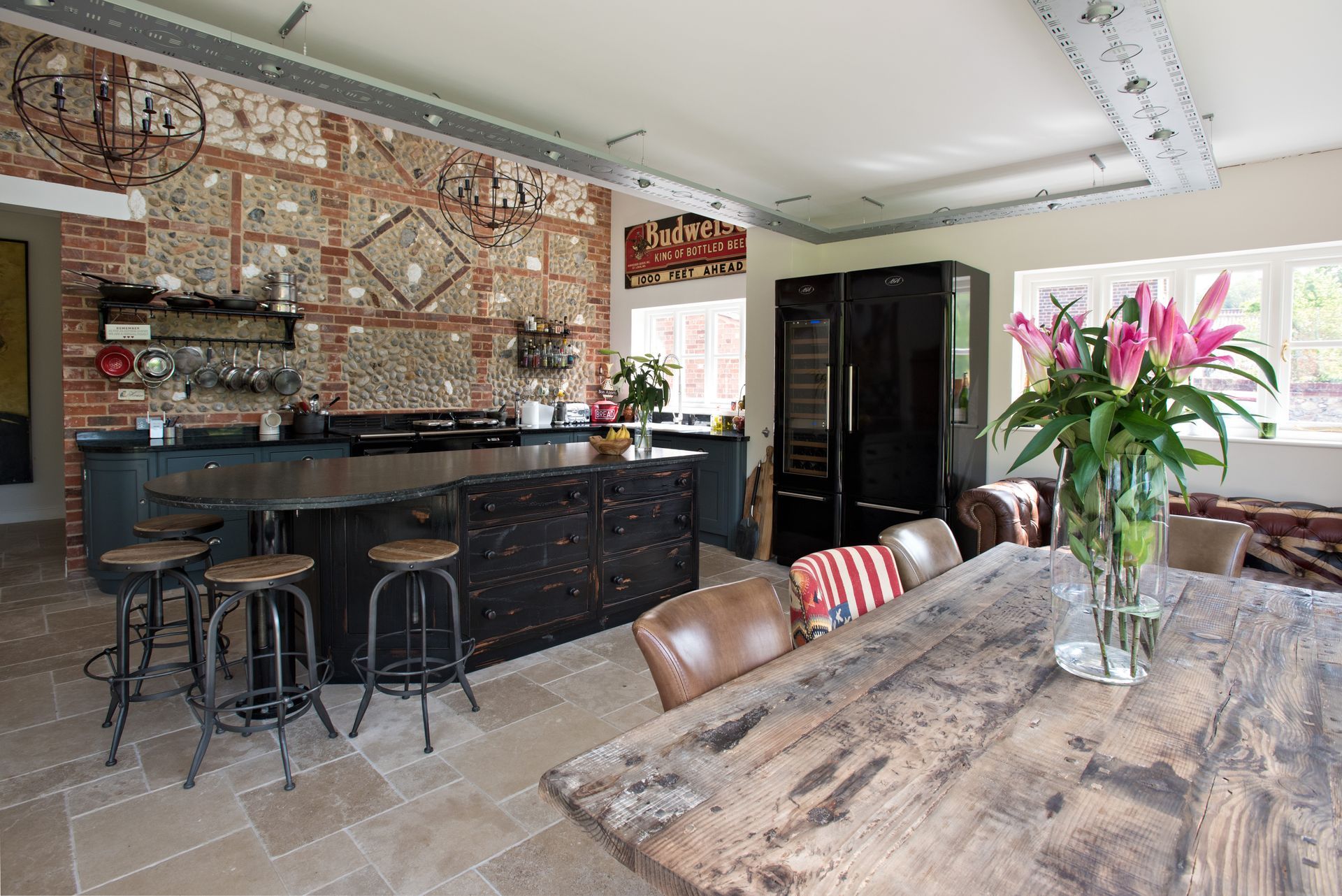 A kitchen with a stainless steel refrigerator and a sink.