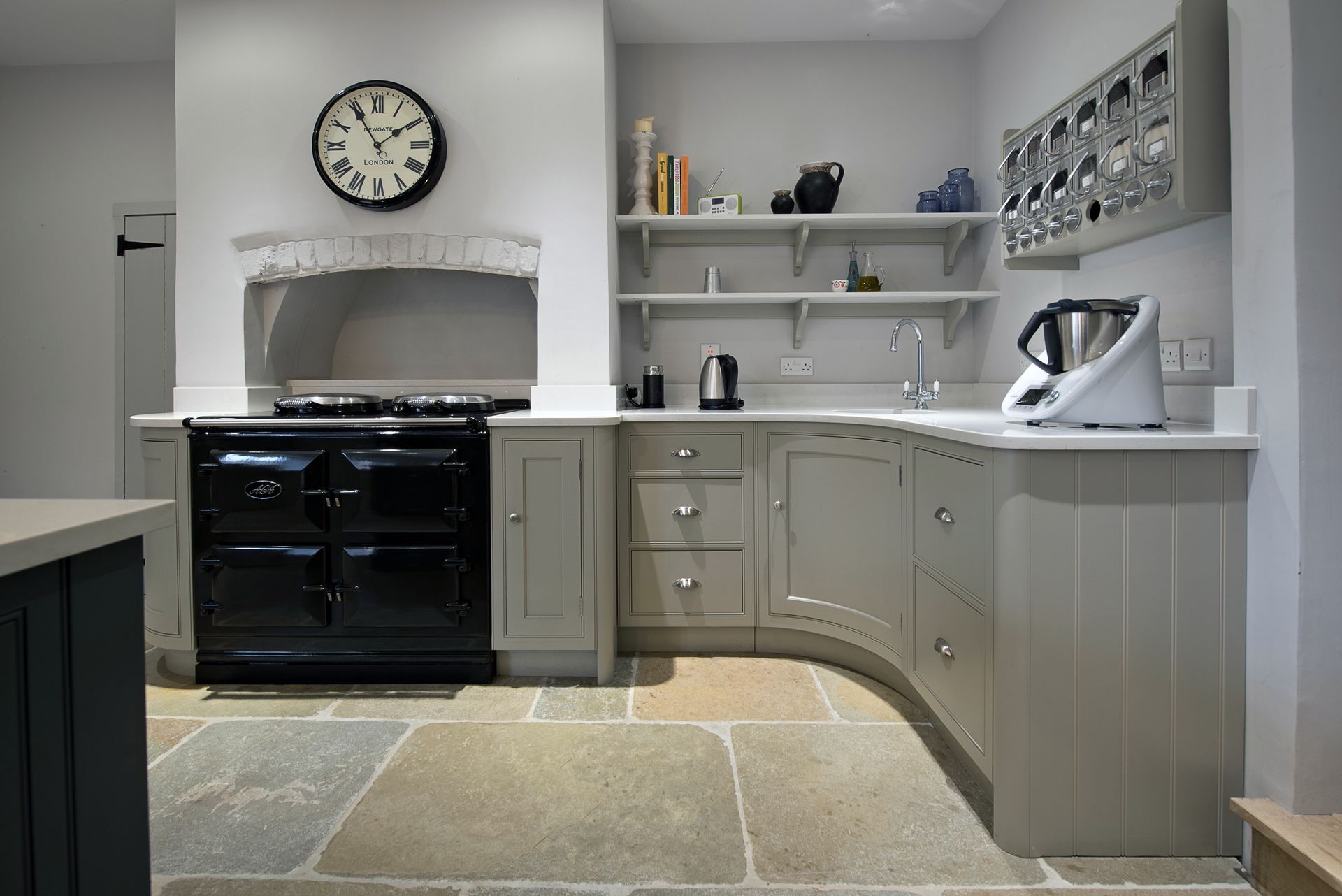 A kitchen with a large island and wicker bar stools.