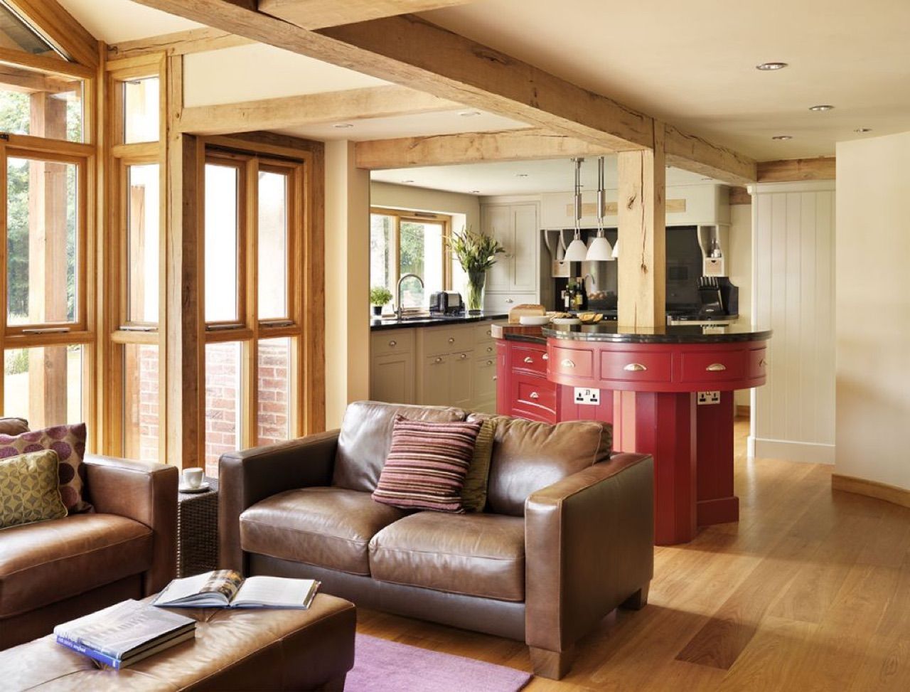 A living room with a brown leather couch and a coffee table