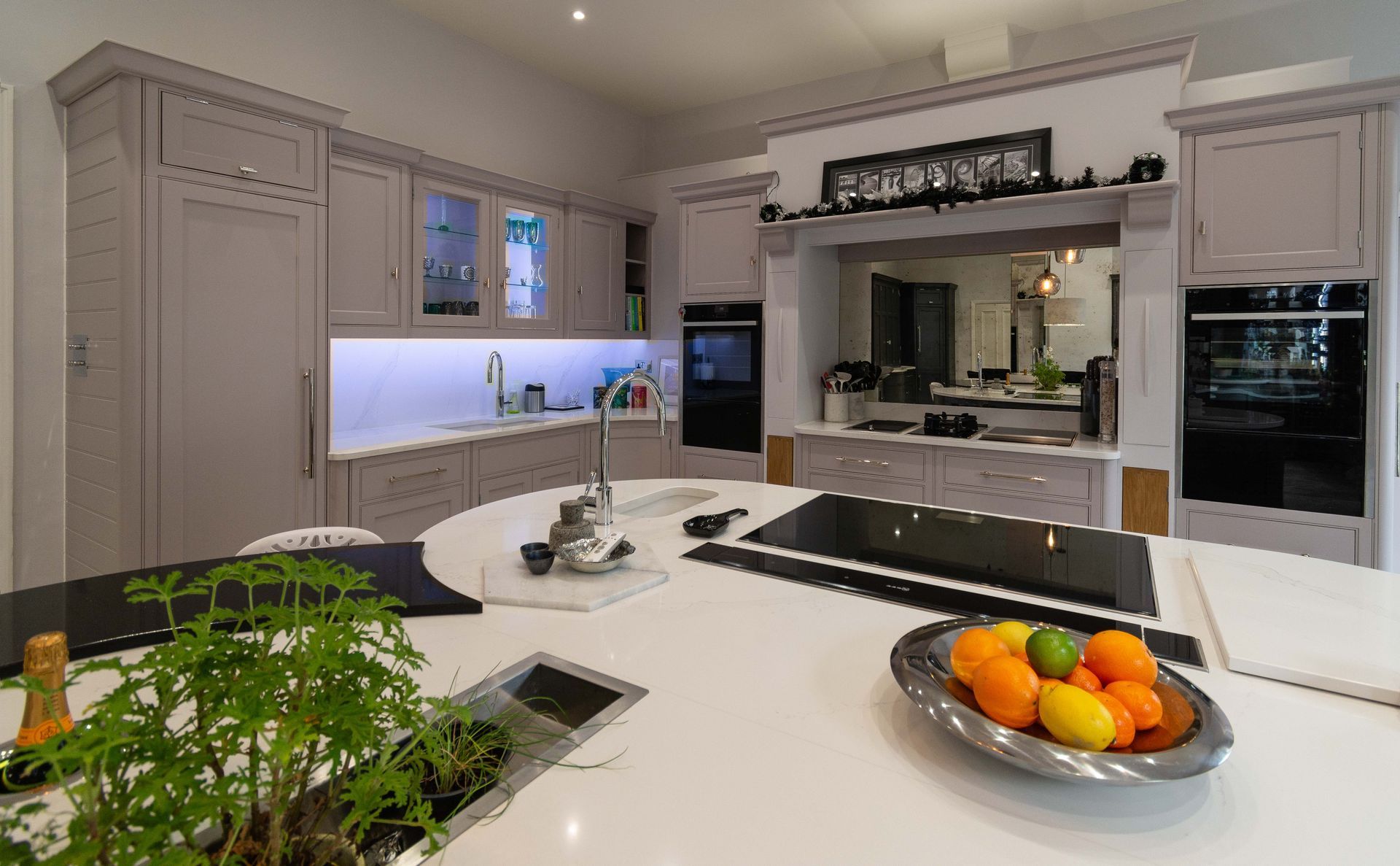 A kitchen with a stainless steel refrigerator and a sink.