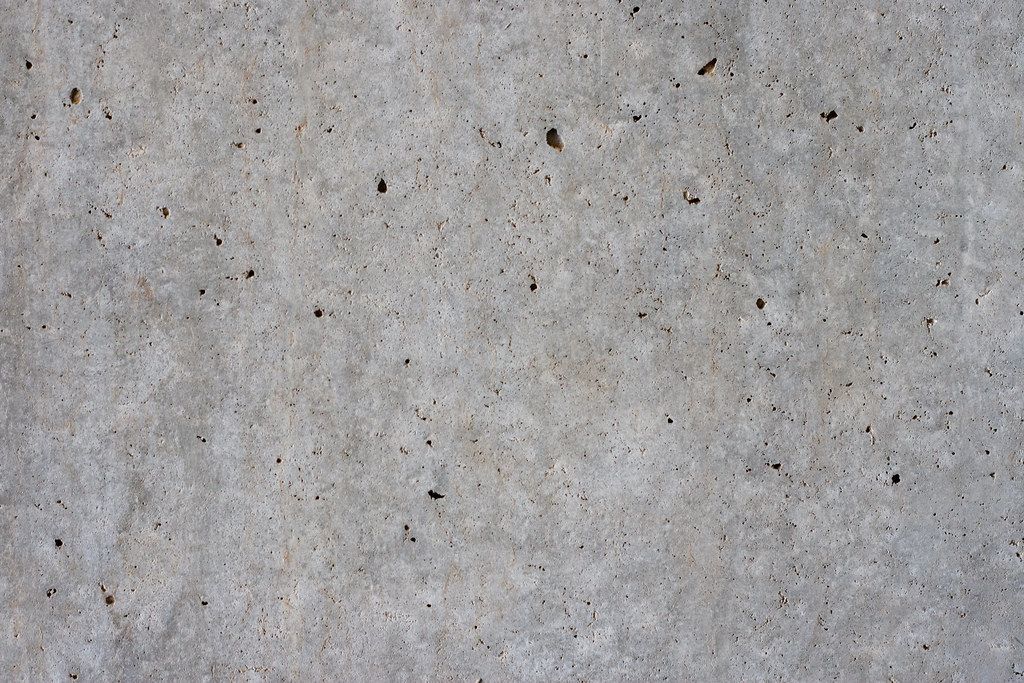 A close up of a concrete surface with small holes in it.