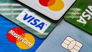 Close-up view of several stacked credit and debit cards featuring Visa and Mastercard logos and a security chip.
