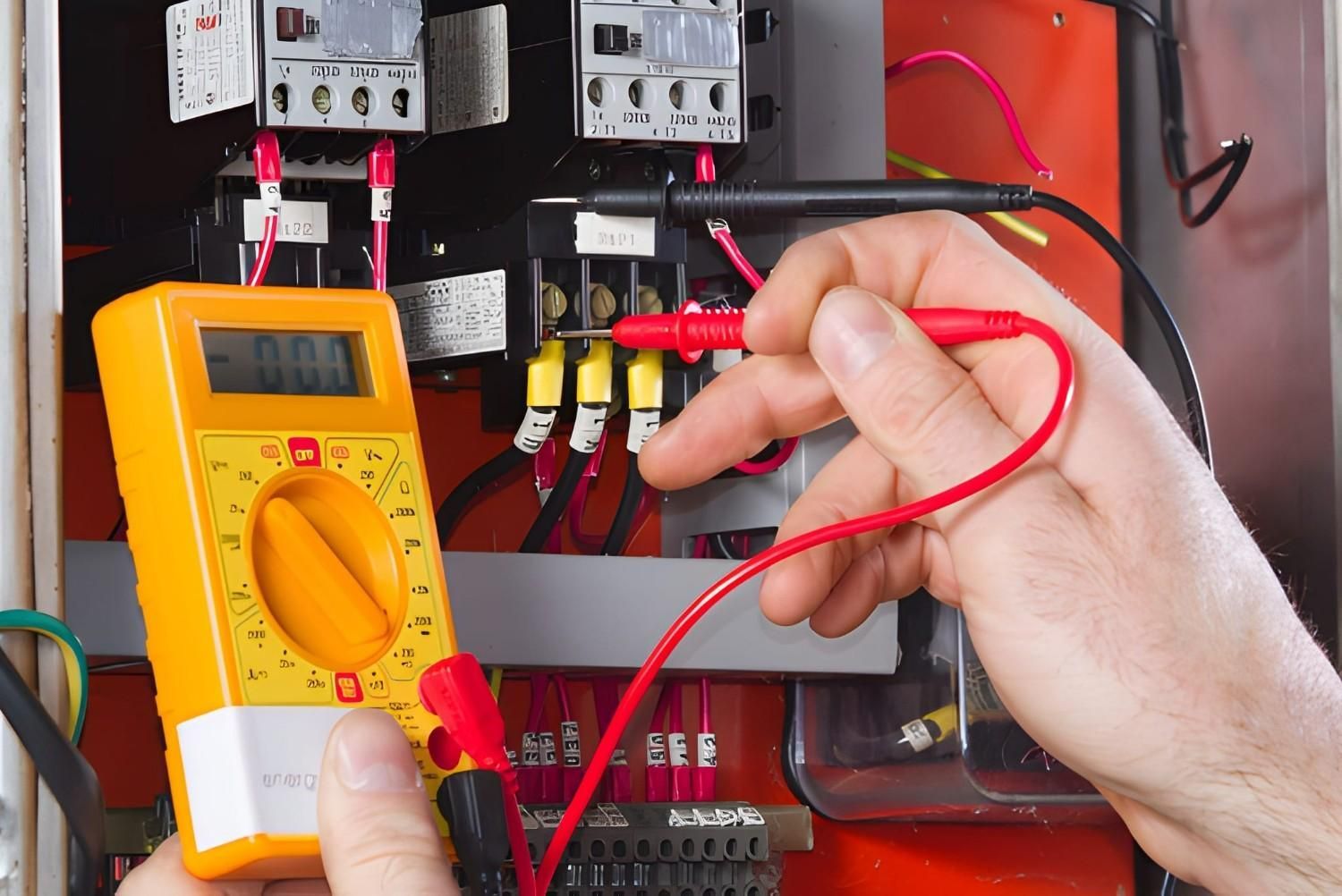 A Person Uses Multimeter to Test Electrical Wires in A Control Panel — Careda Air in Vincentia, NSW