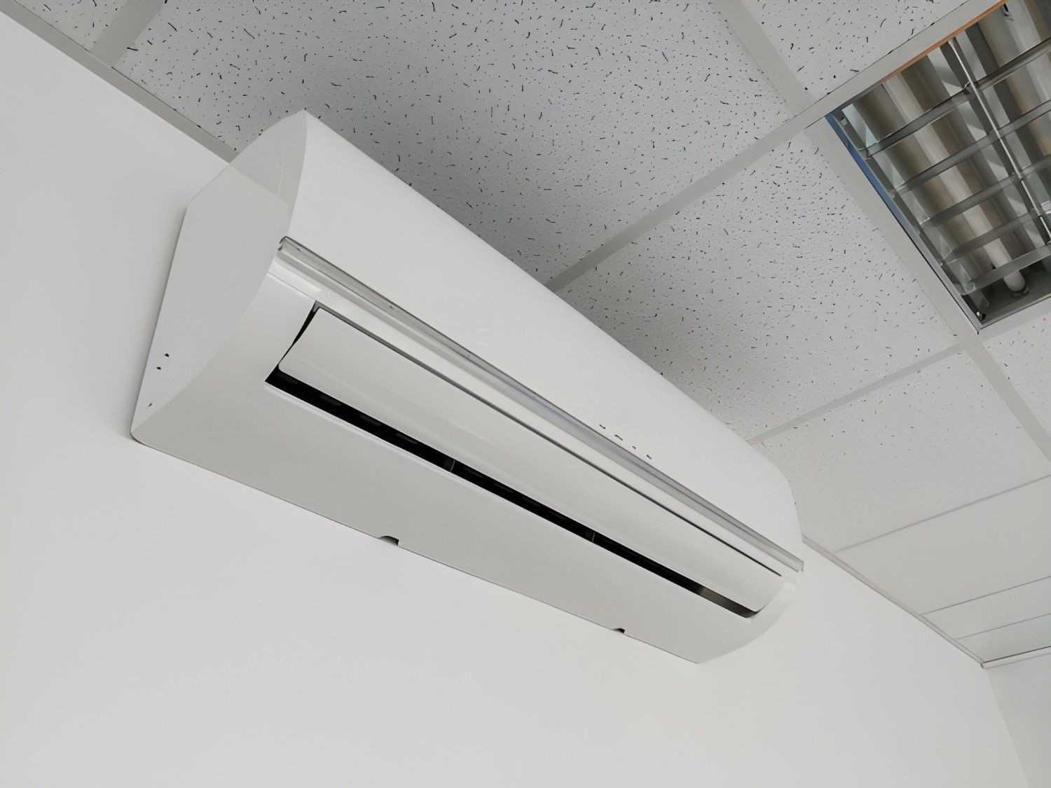 A White Air Conditioning Unit Mounted on A White Wall — Careda Air in Kiama, NSW