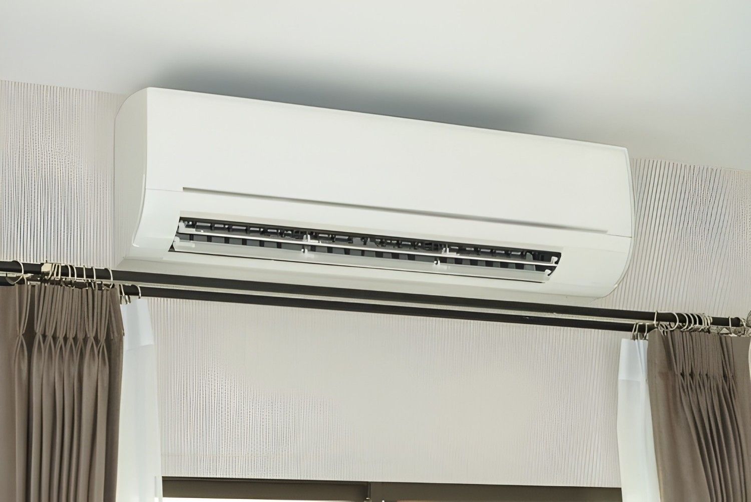 A White Air Conditioning Unit Mounted Above a Window — Careda Air in Vincentia, NSW