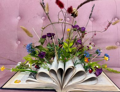 Colorful gerbera daisy bouquet with a ribbon, arranged in a store display on a counter