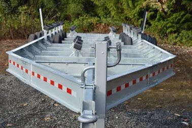 Boat trailer with rollers and reflective tape.