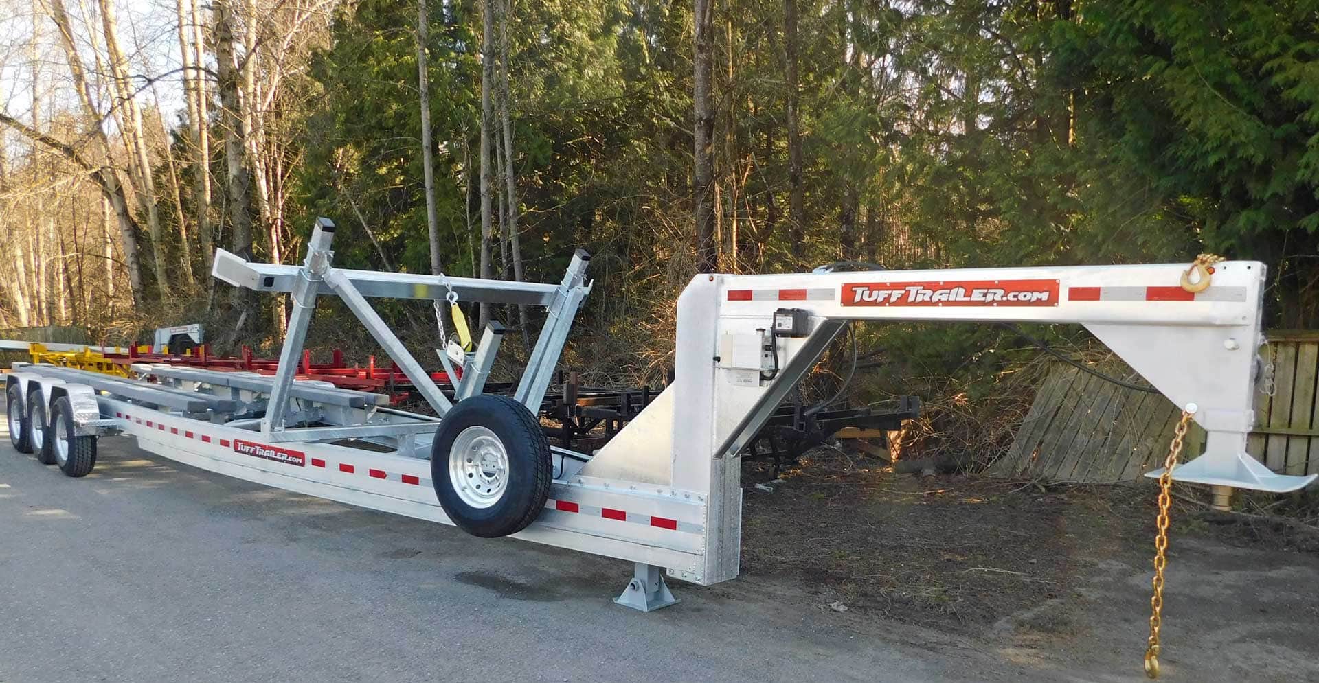 White and red equipment trailer parked outdoors.
