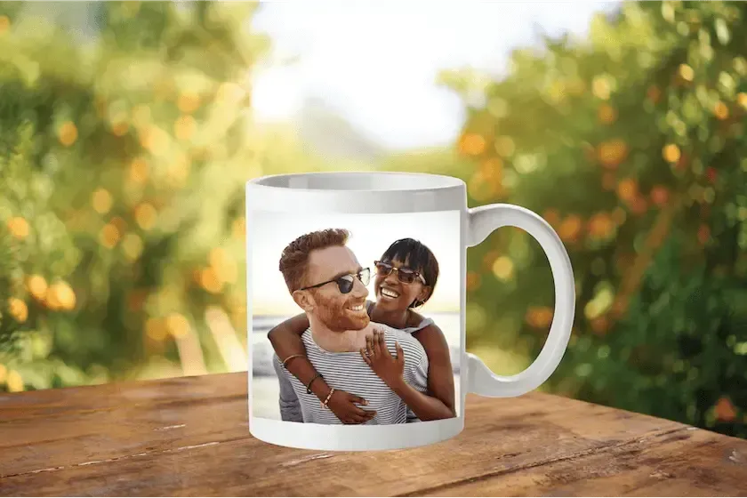 A white coffee mug with a picture of a man and a woman on it