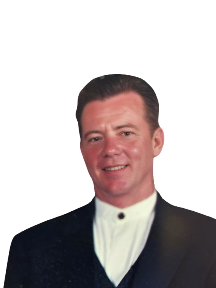 A man in a tuxedo is smiling for the camera